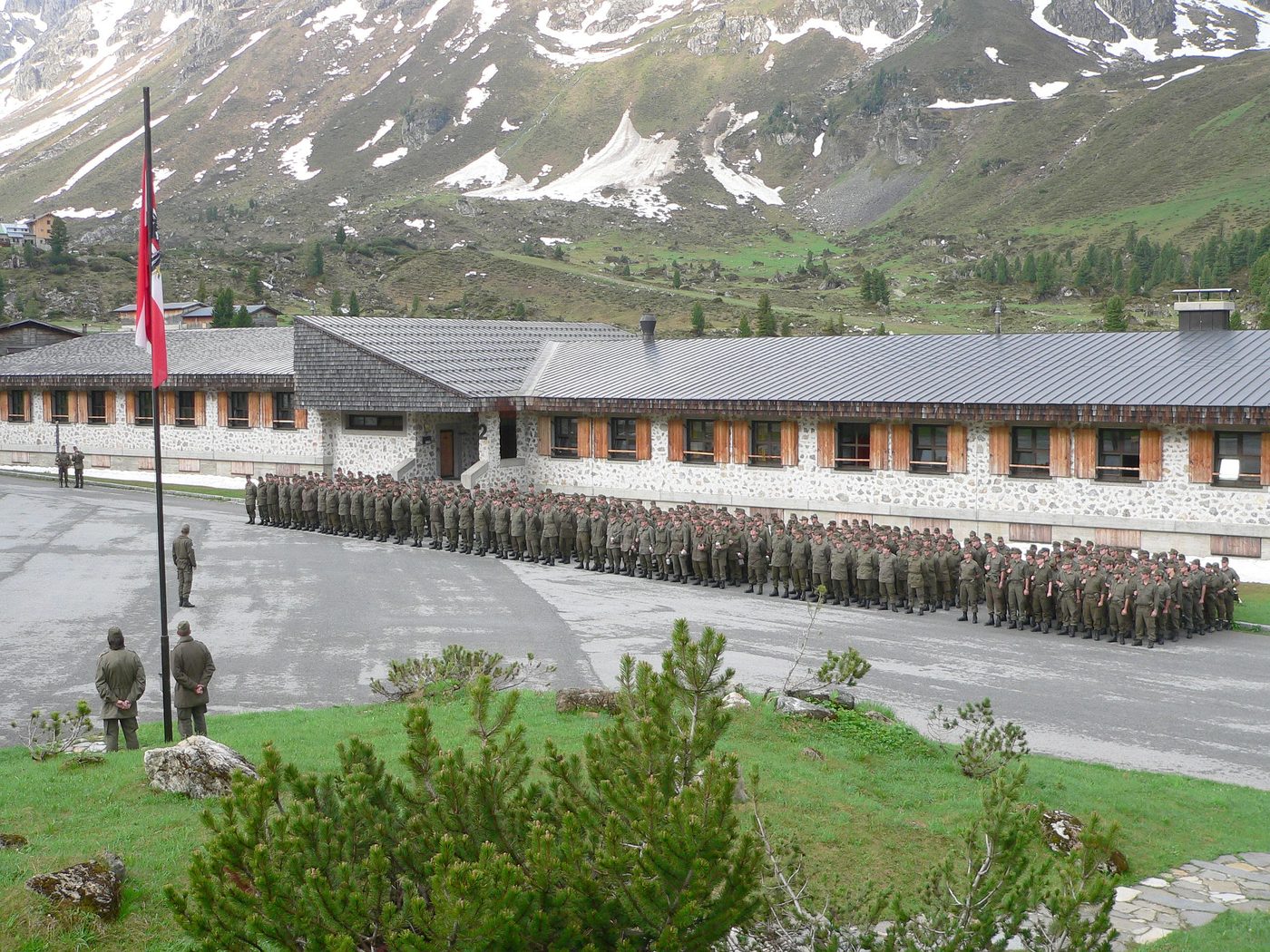 Angetretene Soldaten vor einer Kaserne im Hochgebirge